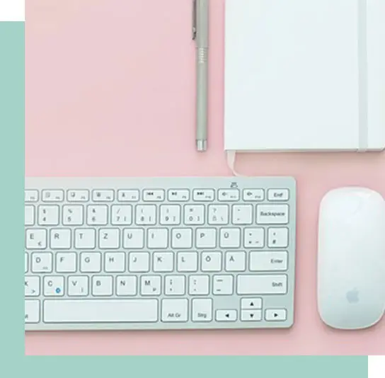 Pink desk with mouse and keyboard
