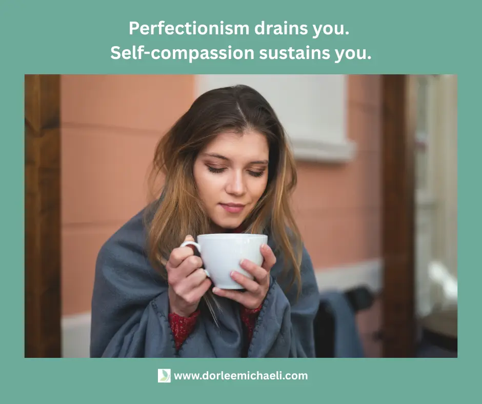 Woman sitting outdoors wrapped in a blanket, holding a warm mug, symbolizing self-compassion for perfectionists taking a pause.